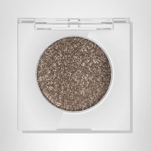 Urban Decay Moondust applying with tapered brush for versatile shimmer.