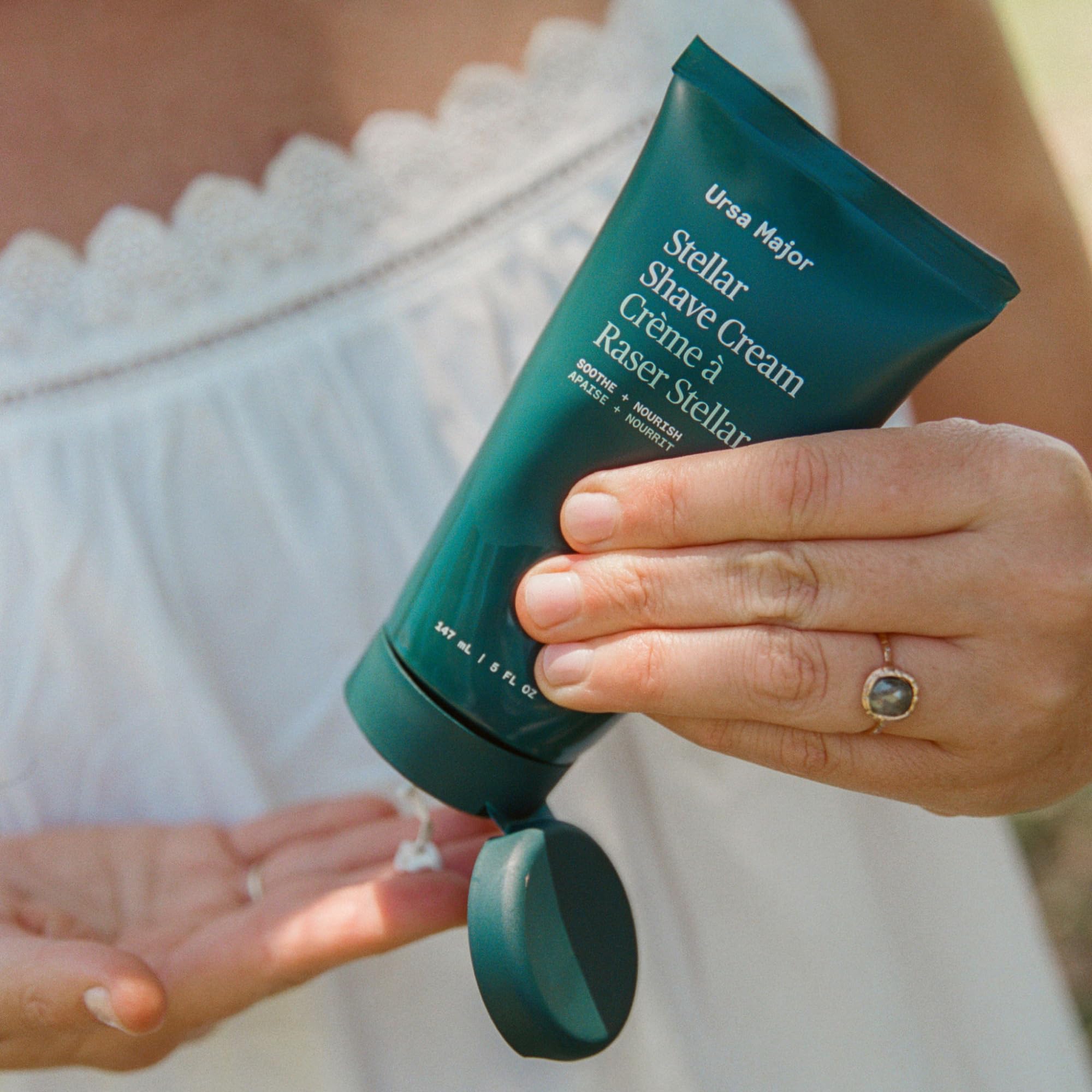 Ursa Major fragrance-free shave cream bottle on clean sink.