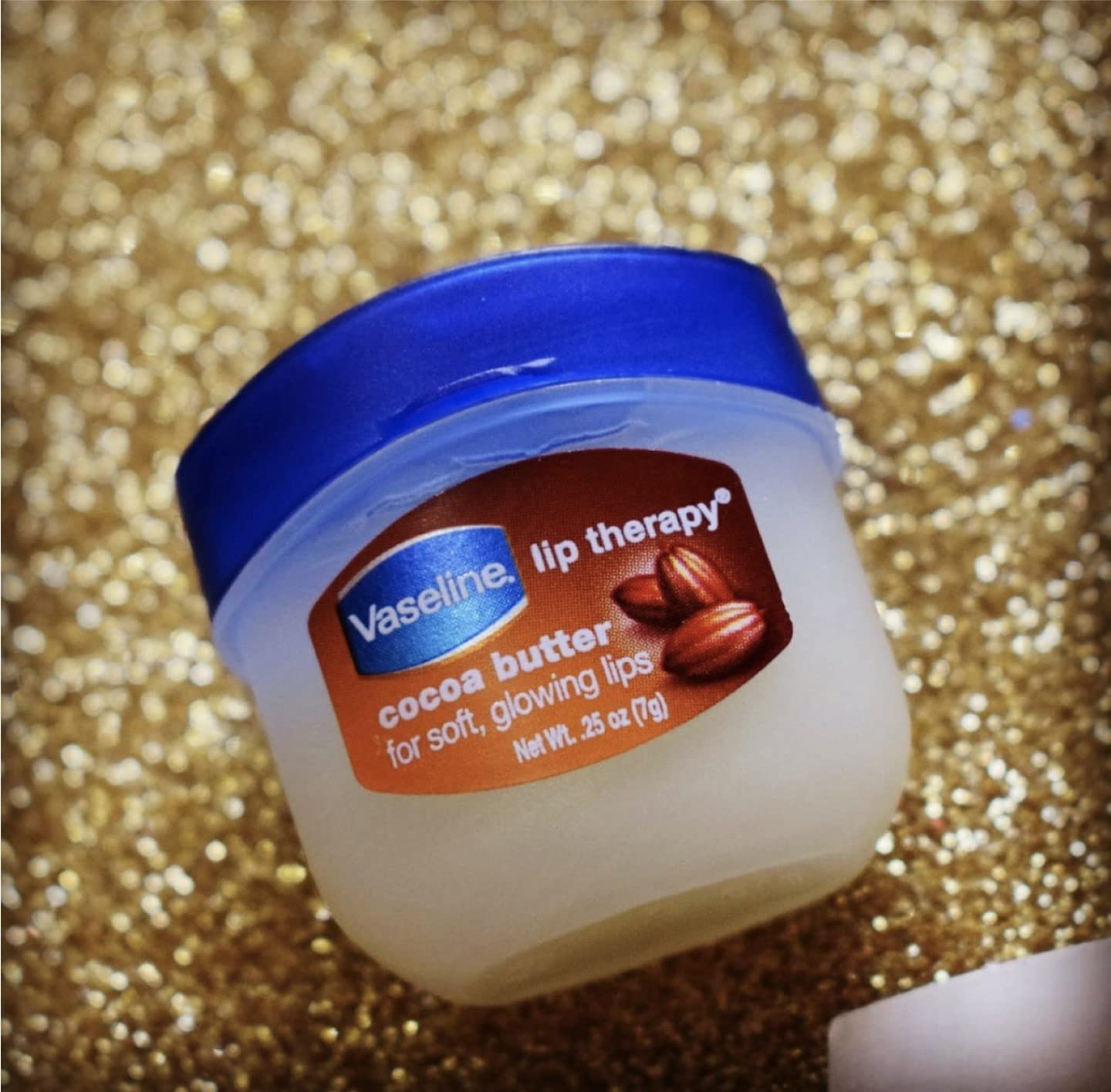 Vaseline Lip Therapy Cocoa Butter texture swatch highlights creamy glide.
