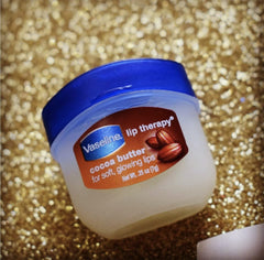 Vaseline Lip Therapy Cocoa Butter texture swatch highlights creamy glide.