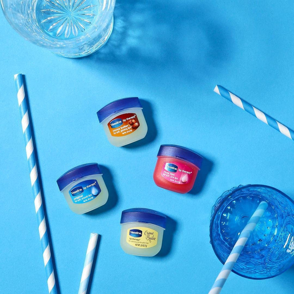 Vaseline Lip Therapy Mini in hand for portable lip care.
