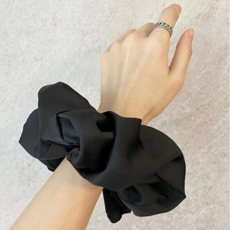 VEDO SHIPIN oversized scrunchie in hand demonstrating gentle grip