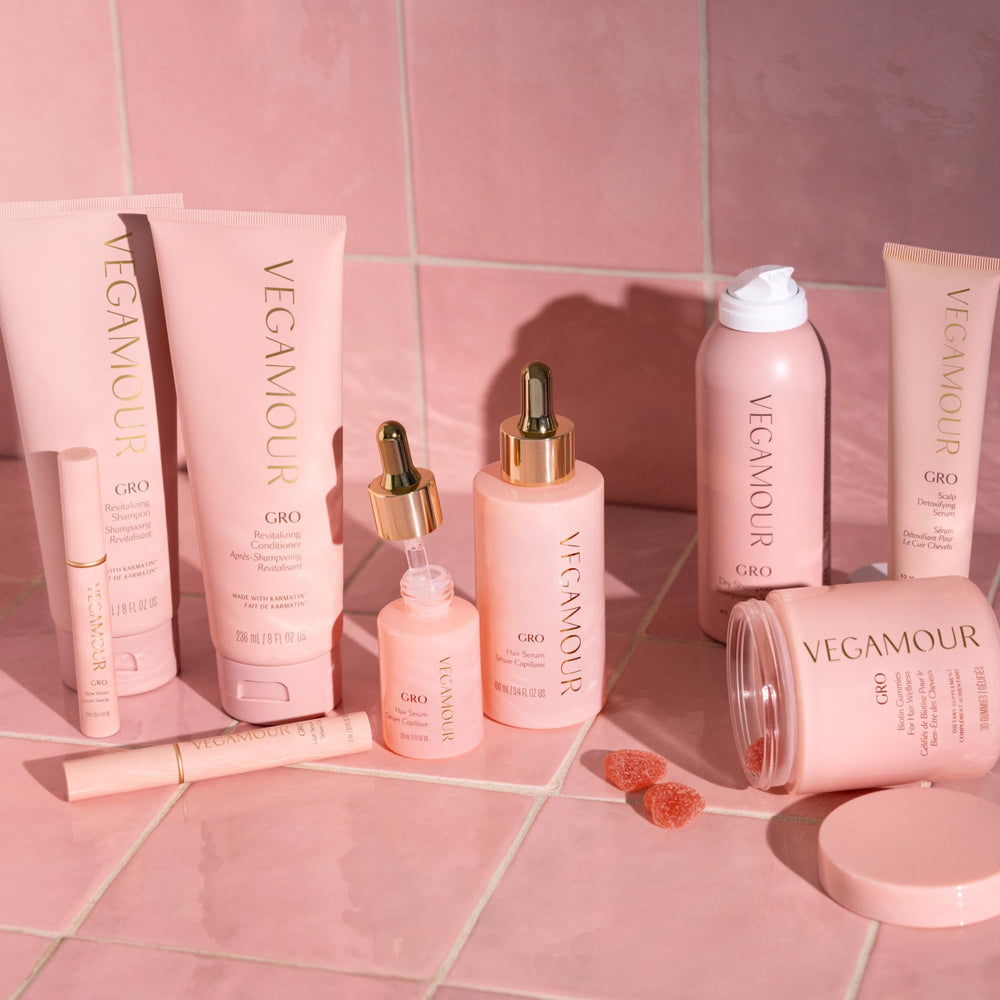 VEGAMOUR GRO Hair Serum resting on towel after shower promotes scalp care.