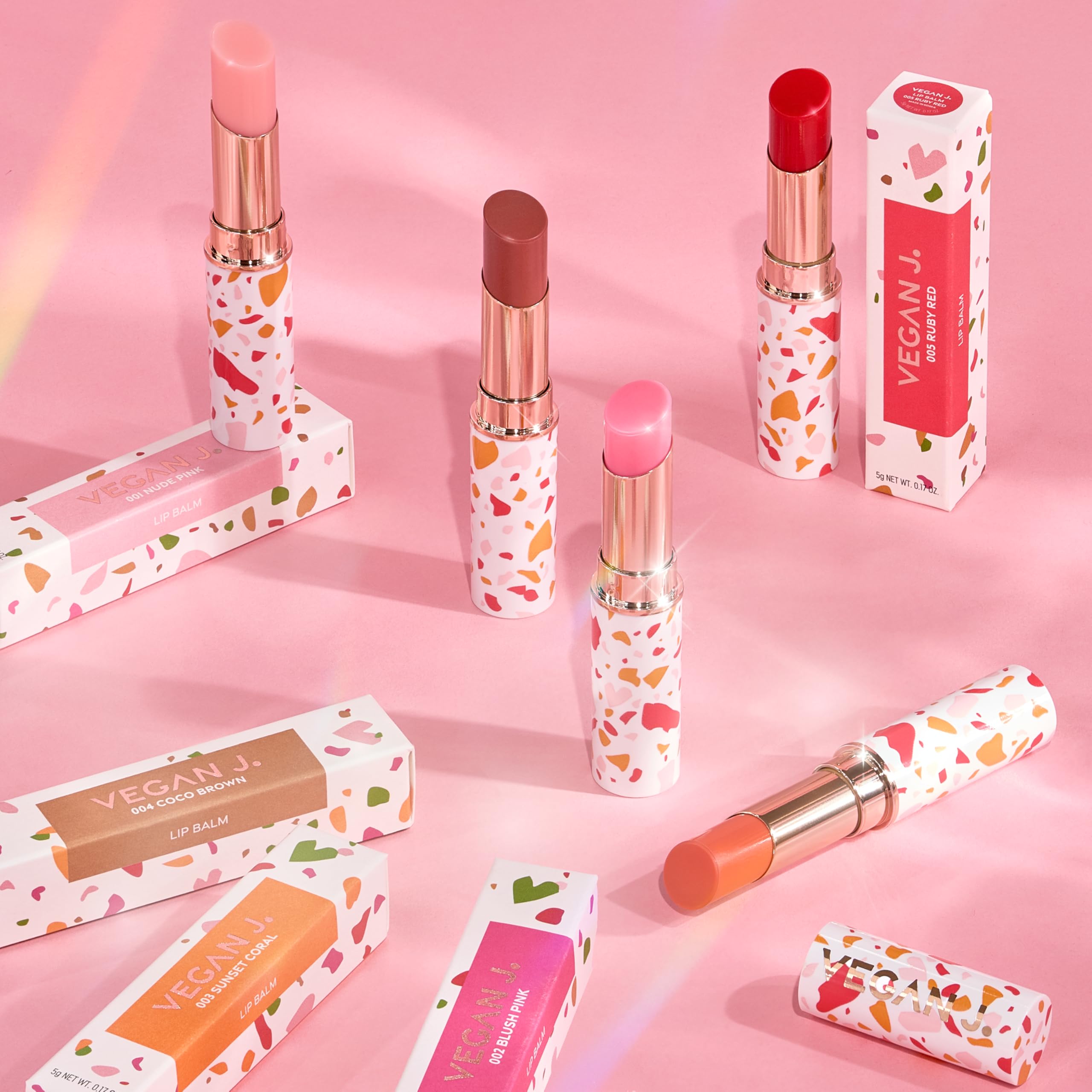 VEGAN J. lip balm cream texture close-up shows smooth, hydrating glide.