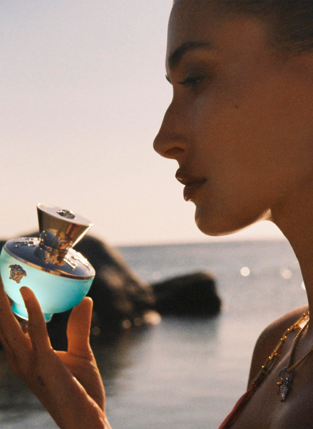 Versace Dylan Turquoise sits on a vanity signaling fresh daytime elegance.