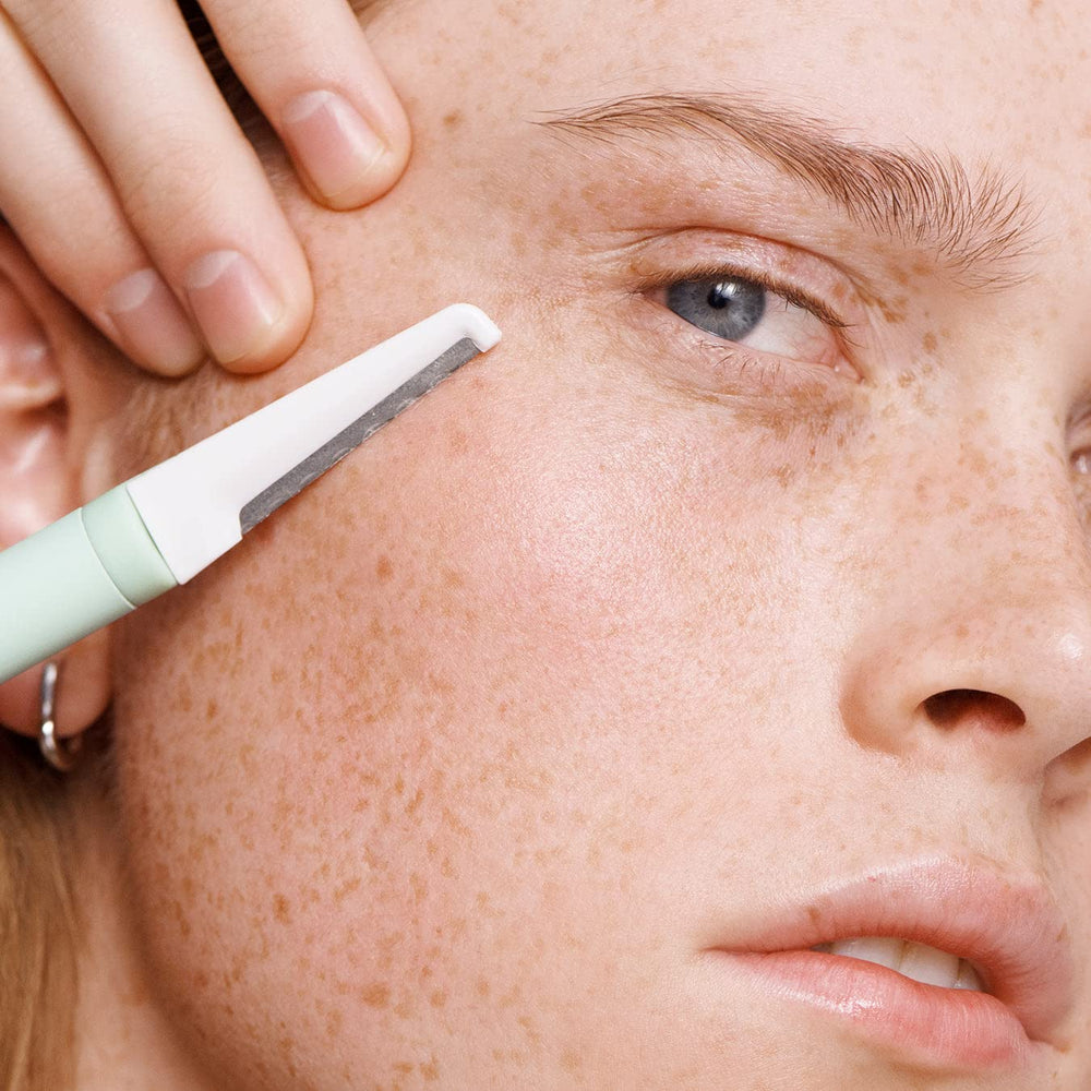 Versed dermaplaning tool used as brow razor for cleanup and shaping.