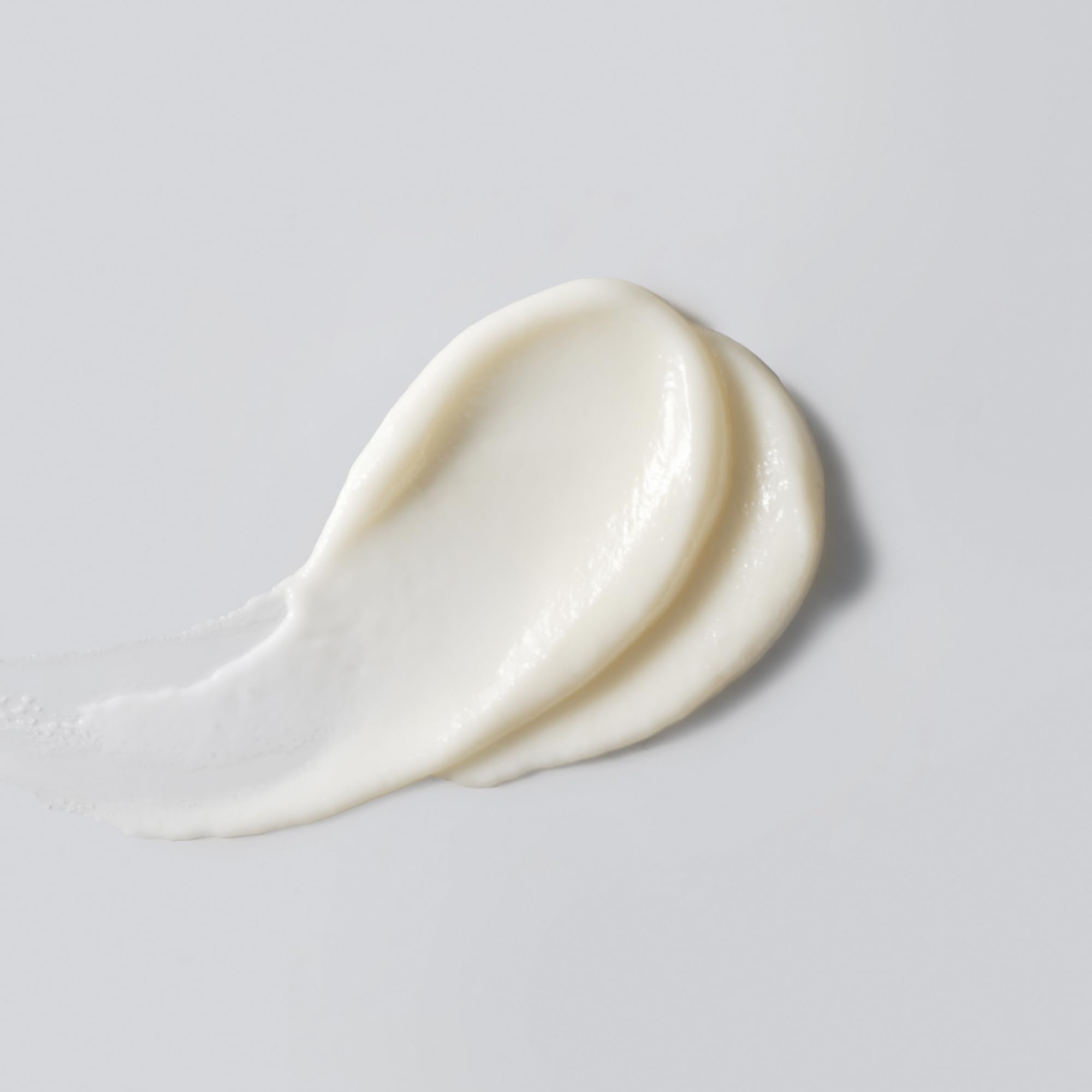 Versed Good Defense sunscreen texture close-up showing hydrating, creamy lotion for daily use.