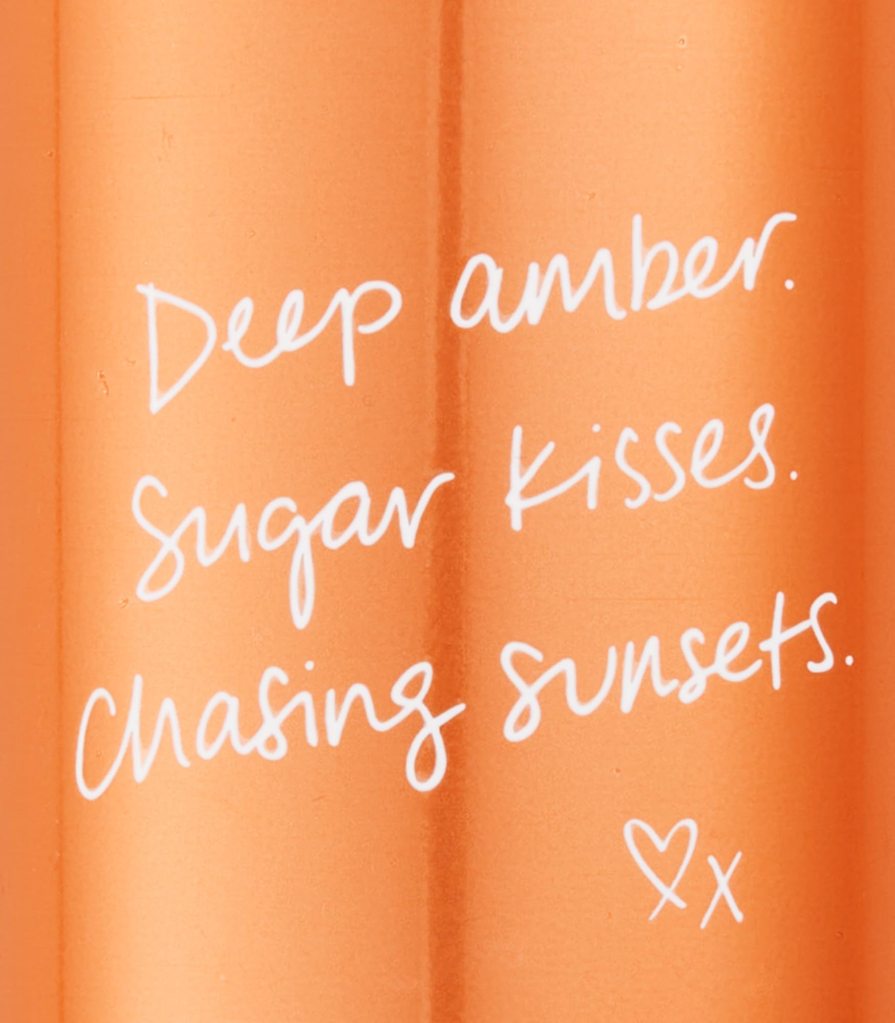 Victoria's Secret Amber Romance scent notes close-up reveal amber and sugar-sweet warmth.