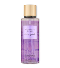 Victoria's Secret Love Spell mist bottle close-up highlighting peach and cherry blossom notes for a delicate scent.