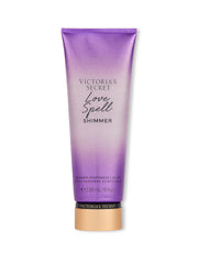 Victoria's Secret Love Spell Shimmer Fragrance Lotion bottle gleaming with a celebratory shimmer finish for glowing skin.