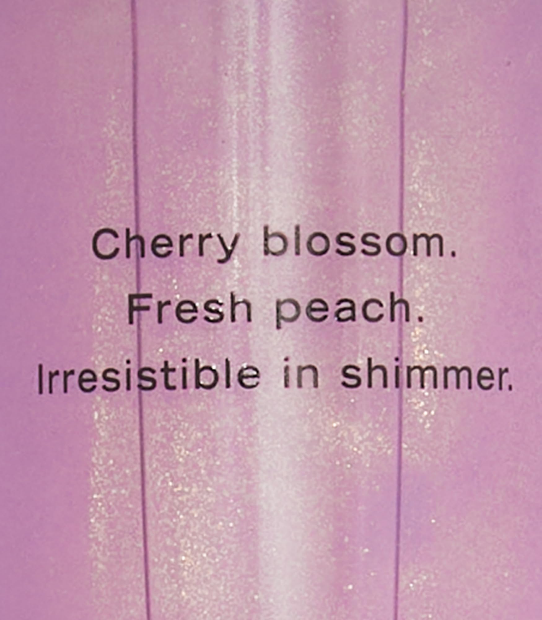 Victoria's Secret Love Spell Shimmer Mist labeled-packaging highlights cherry blossom and peach notes.