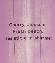 Victoria's Secret Love Spell Shimmer Mist labeled-packaging highlights cherry blossom and peach notes.