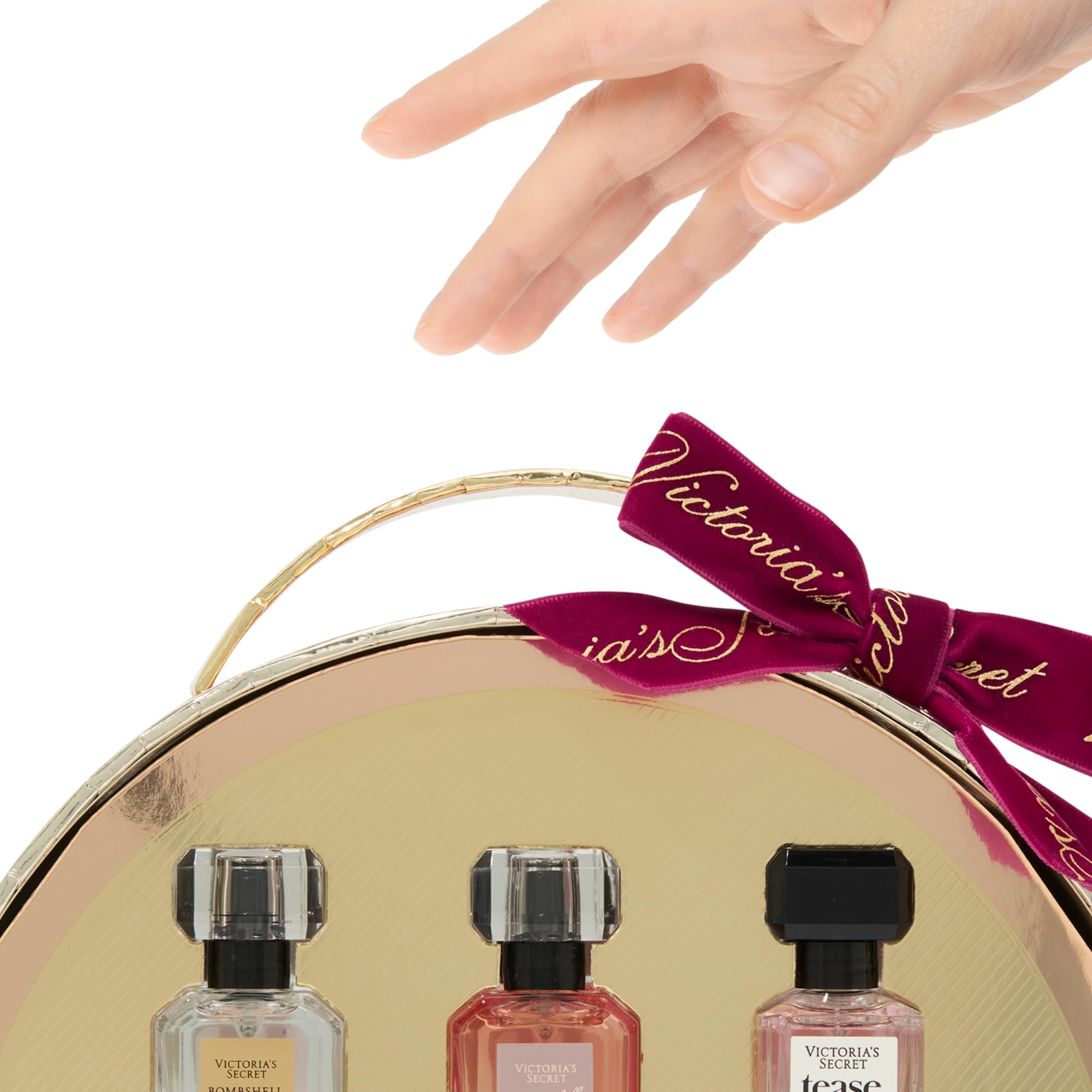 Victoria's Secret Tease mini bottle close-up reveals white gardenia and pear for flirtatious glow.