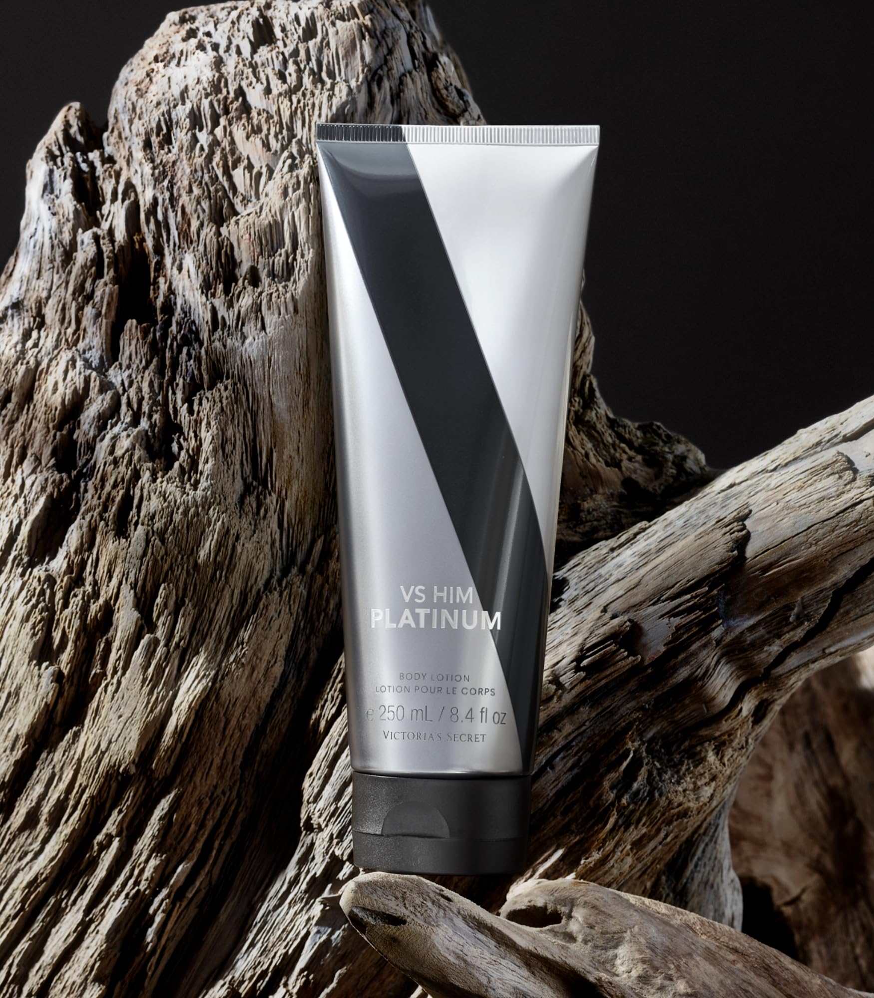 Victoria's Secret VS Him Platinum lotion close-up showing violet leaf accent for subtle softness.