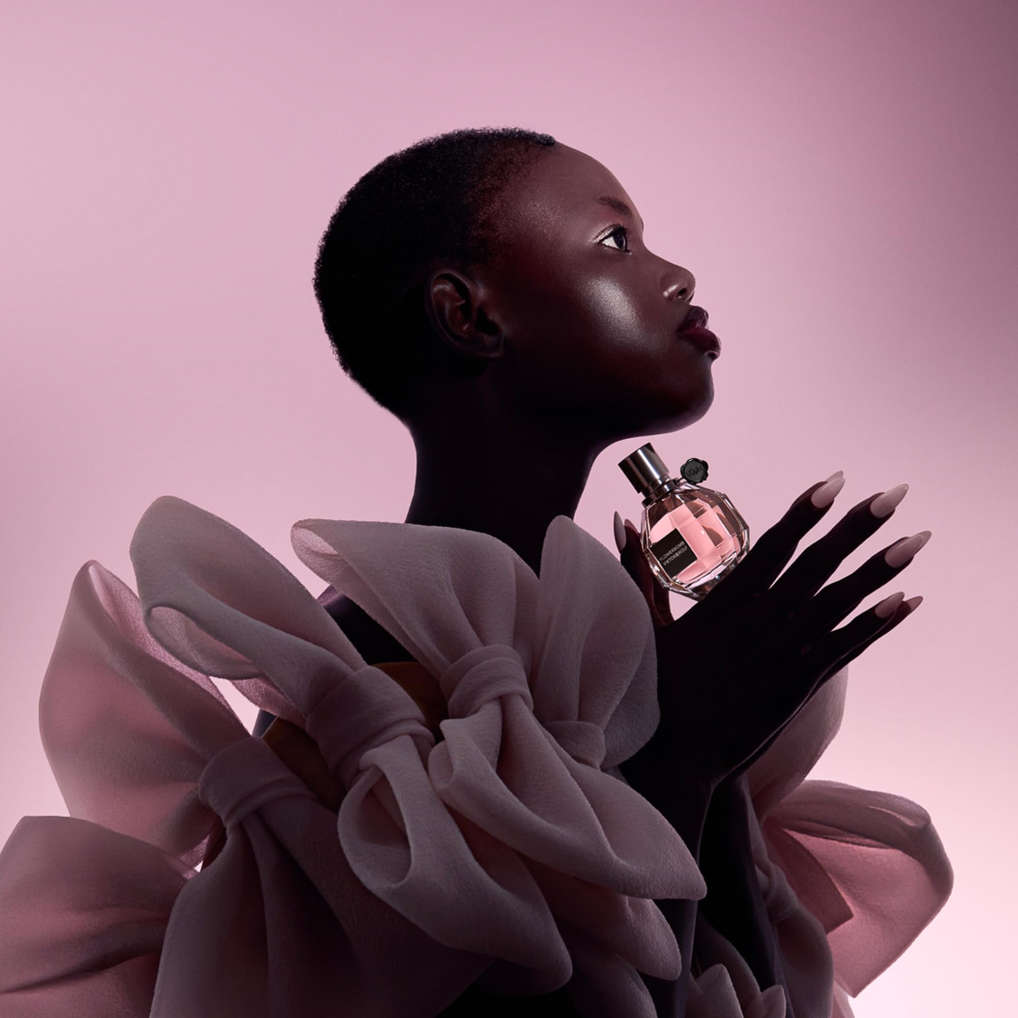 Viktor&Rolf Flowerbomb travel-size on vanity illustrates portable luxury scent rituals.