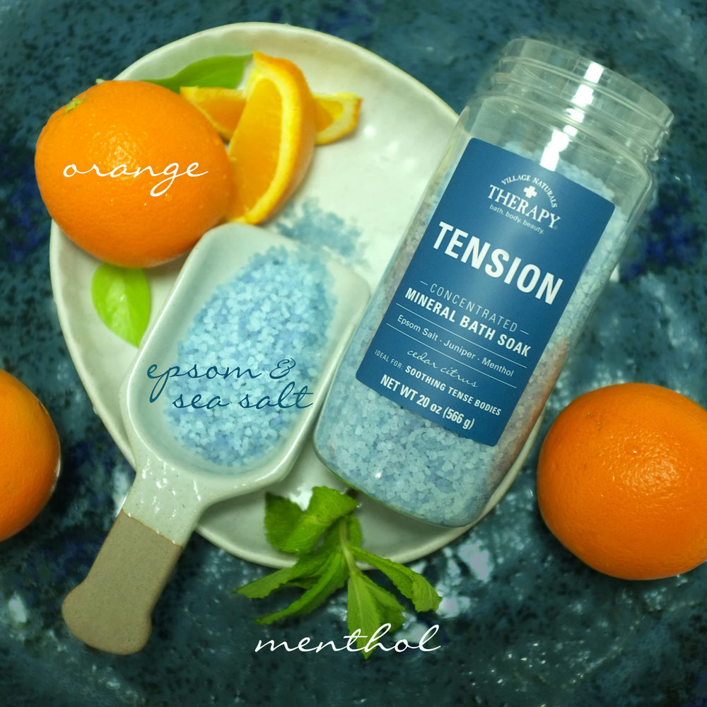 Village Naturals Therapy tension bath soak Cedar Citrus bottle being poured into warm water