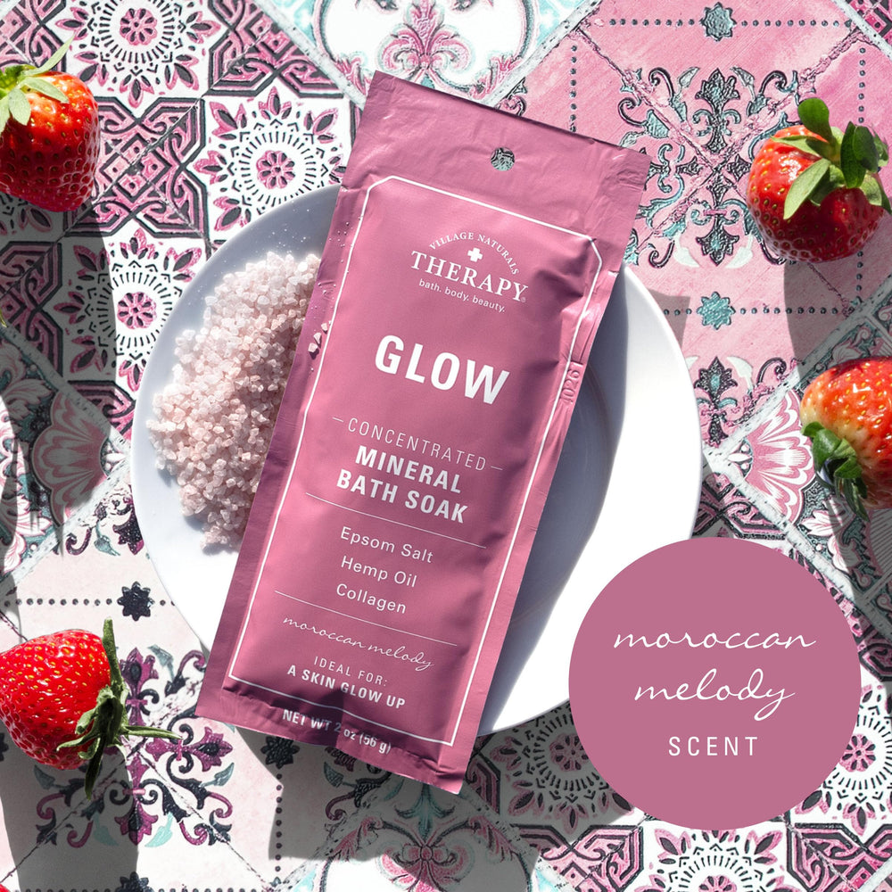 Glow bath soak being poured into a warm tub.