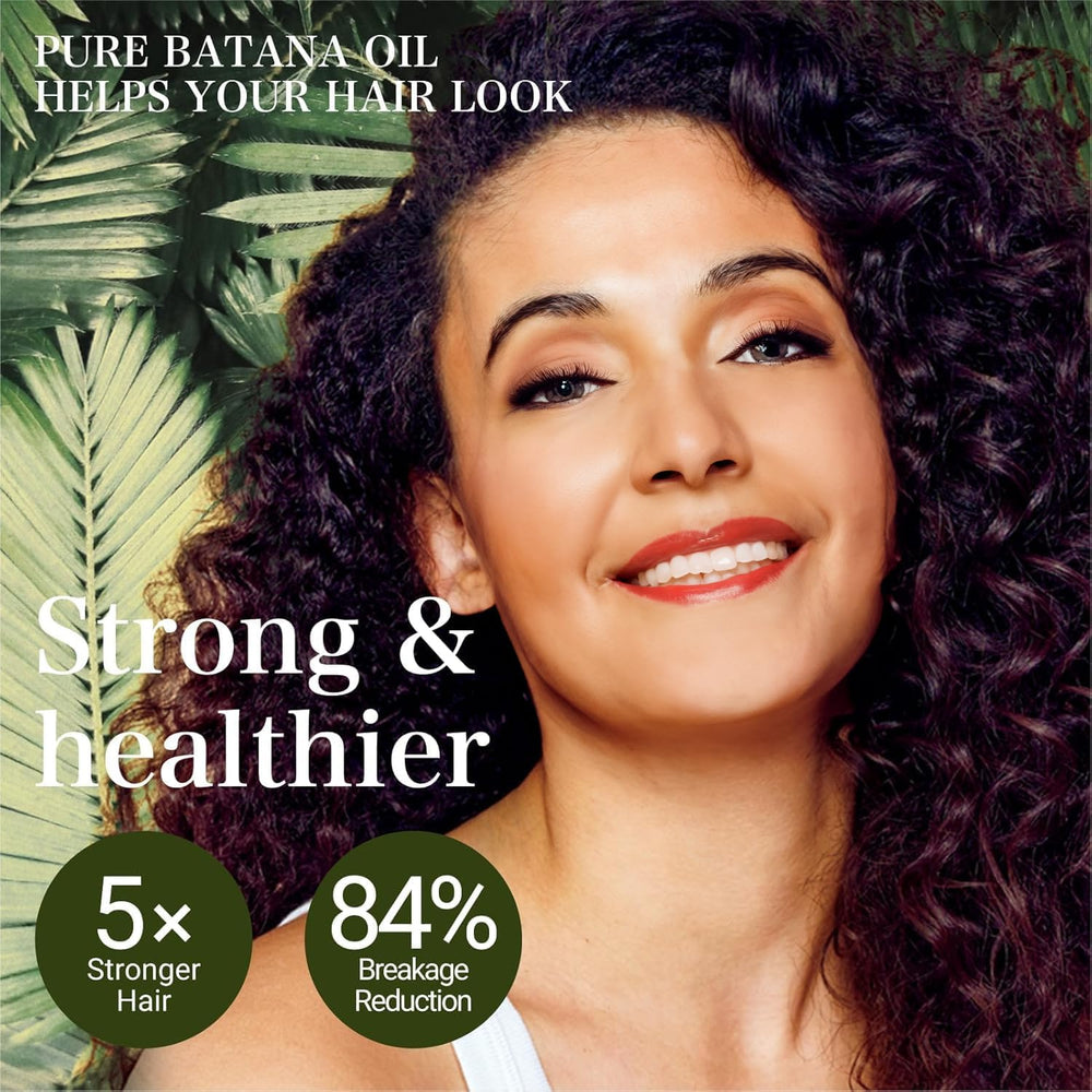 Hands apply VIMOZA Batana oil to the scalp for nourishment.
