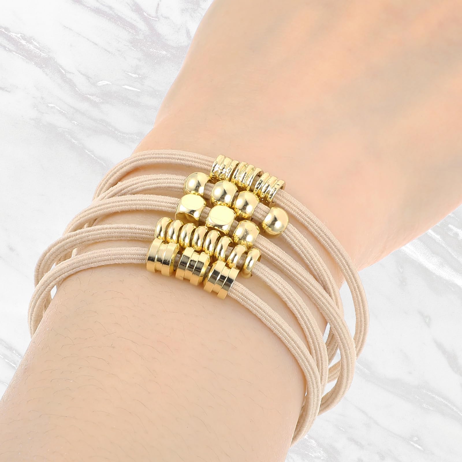WY LIGHTING LEVEL gold-plated hair tie adds secure hold and radiance