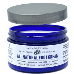 The Yellow Bird tea tree foot cream jar closeup showcases natural, hydrating moisture.