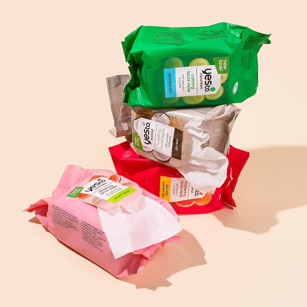 Yes To Cucumbers travel wipes beside passport for holiday ready routine.