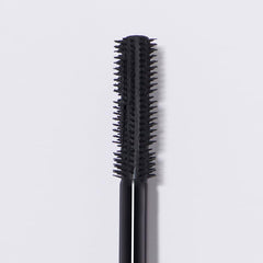 Close-up of the dual-wand applicator delivering defined lashes