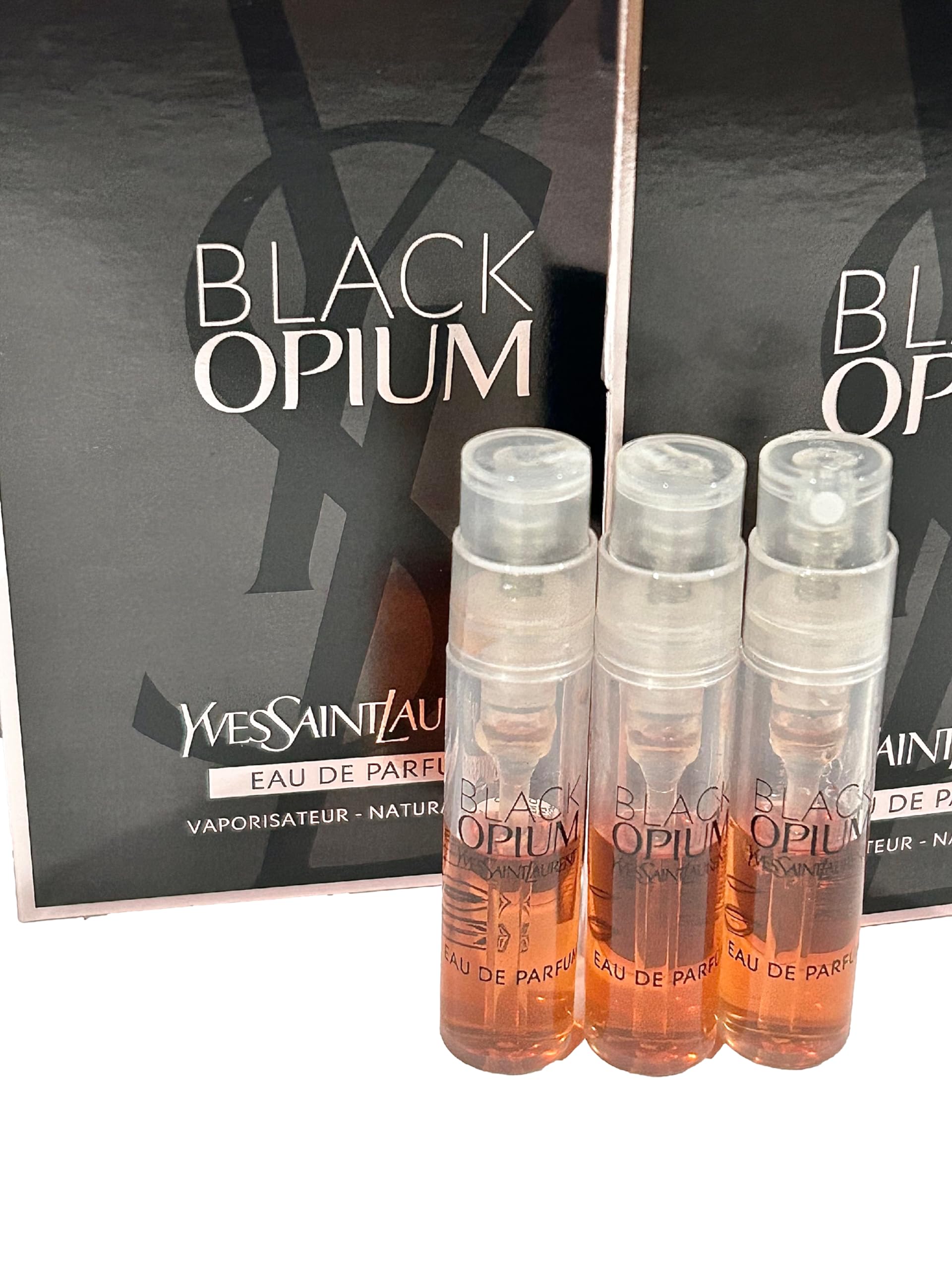 YSL Black Opium spray cap close-up highlighting compact travel size