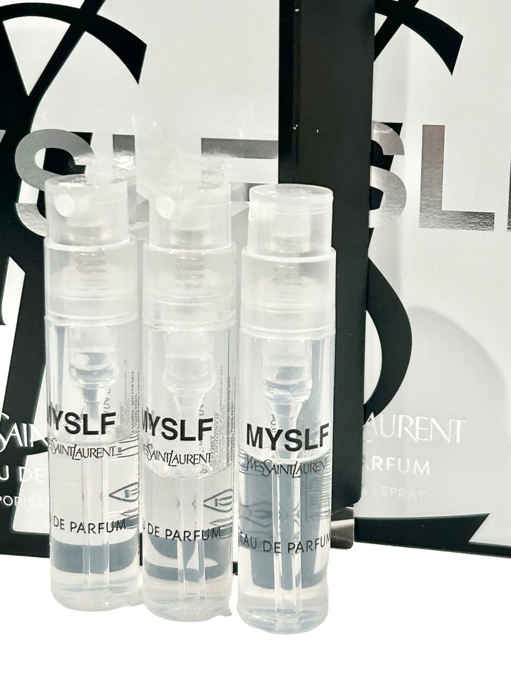 YSL MYSLF partially filled vials close-up showing portable on-the-go sample sizes.