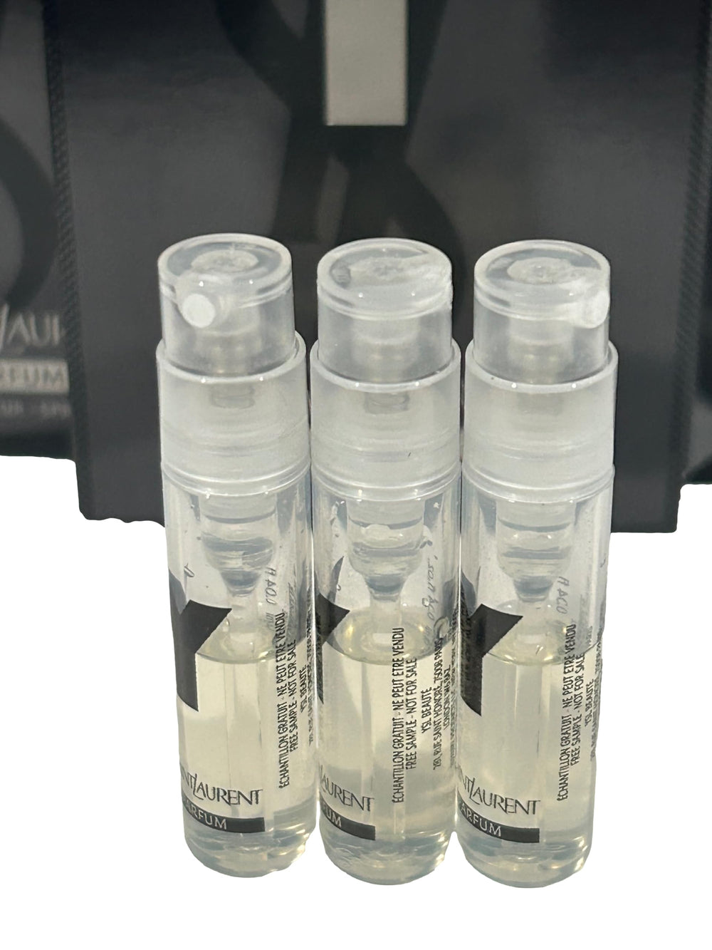 Close-up of Yves Saint Laurent Y Men 1-2ml vial highlighting compact portability.