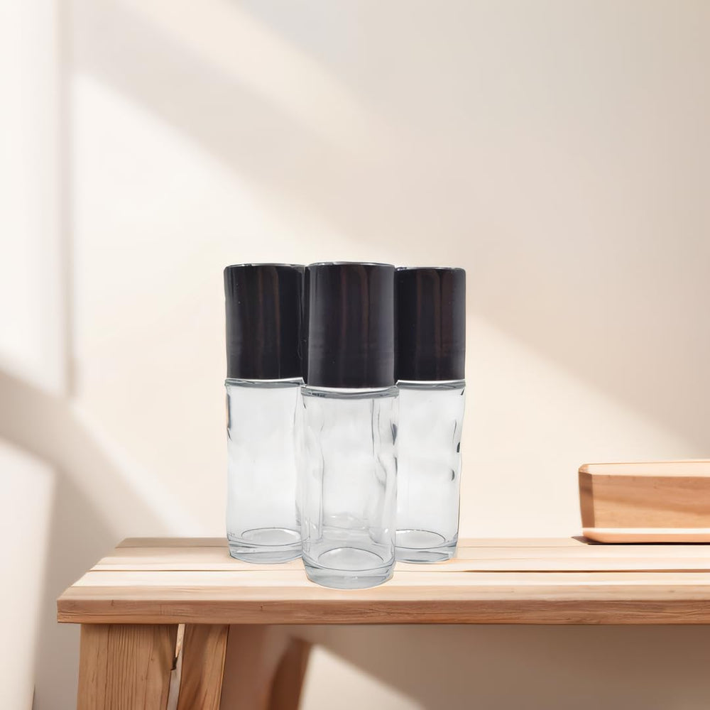 YYNGJCK roller bottle in use with essential oils and blends for personalized fragrance.