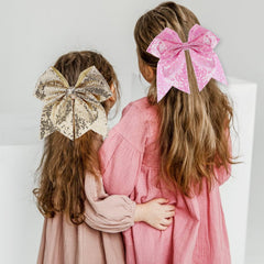 Zolyco 7inch pink cheer bow pony-tail demonstrates versatile hair styling option