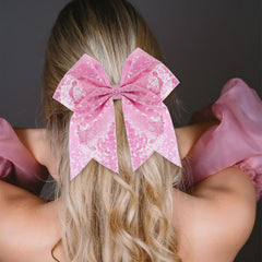 Zolyco large glitter cheer bow pink on head shows eye-catching accessory for teens